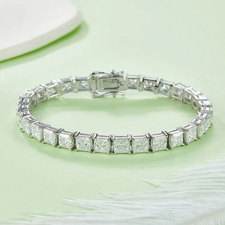 A detailed view showcasing the sparkle of the princess cut moissanite stones and the polished sterling silver setting of this elegant bracelet.