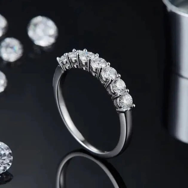 A stunning 9ct white gold wedding band set featuring a half-eternity row of seven sparkling moissanite stones.