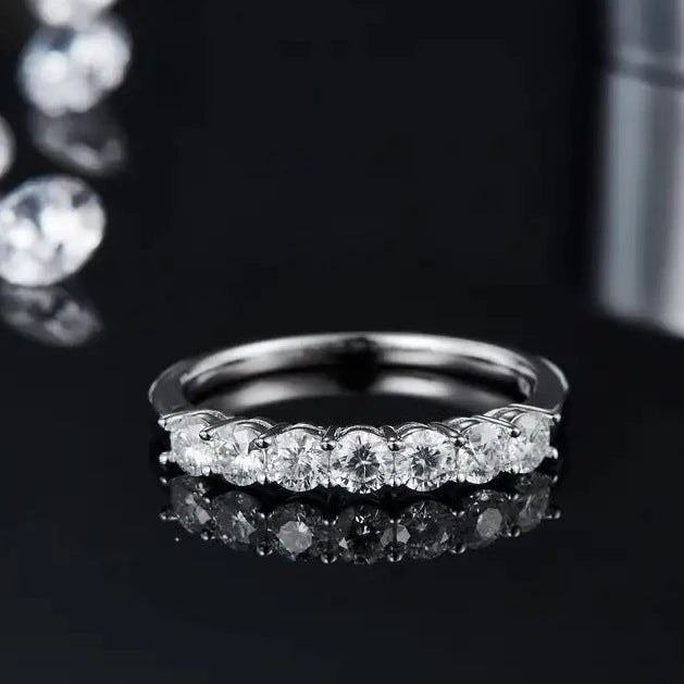 This sophisticated wedding band set features a half-eternity row of seven stones, creating a timeless and elegant look.