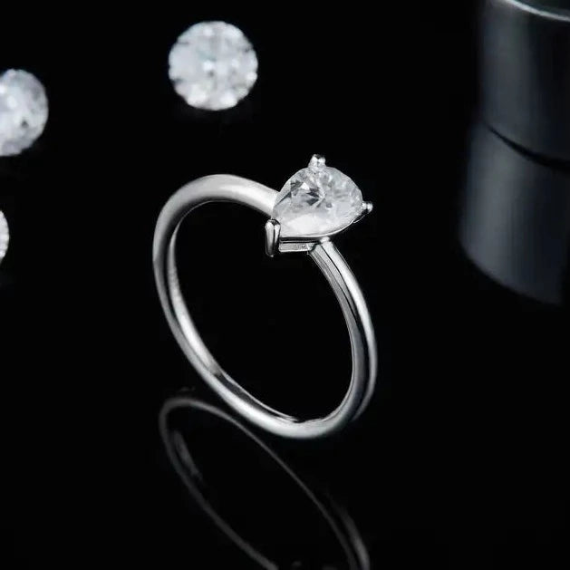 A classic and sophisticated ring featuring a 1.00ct pear-shaped moissanite solitaire.