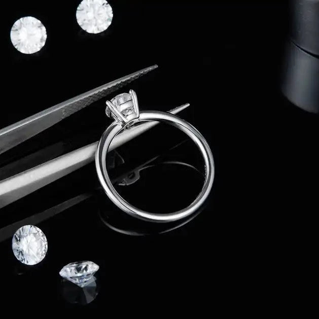 A delicate and understated engagement ring featuring a 1.00ct pear-shaped moissanite in a clean sterling silver setting.