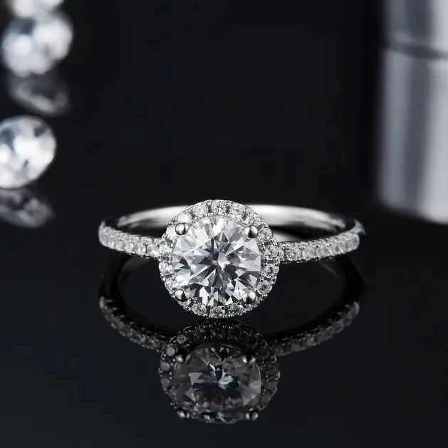 A radiant engagement ring with a 1.00ct moissanite center stone and a shimmering halo.