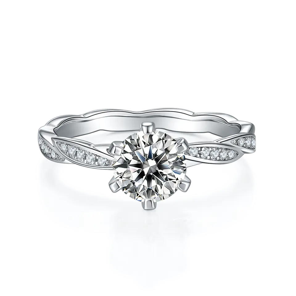 This set includes a 1.00ct moissanite engagement ring with delicate vintage details and a matching sterling silver band.
