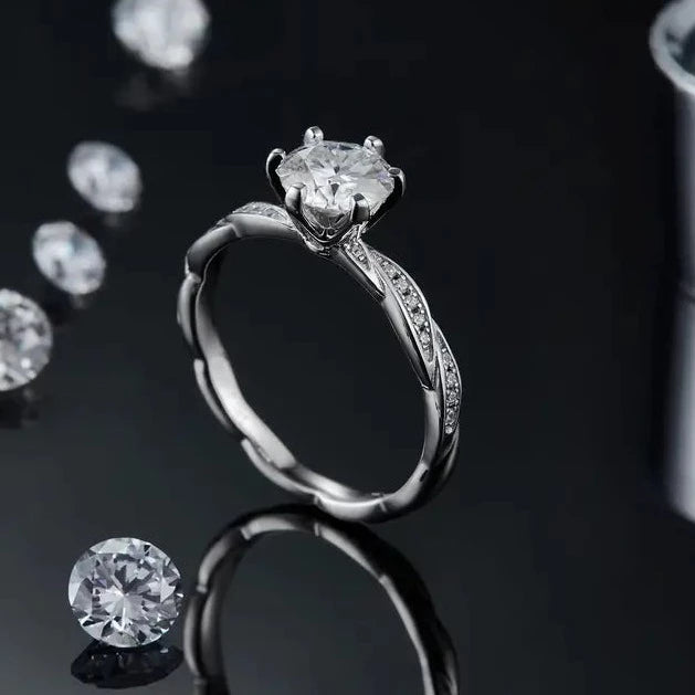This ring features a 1.00ct moissanite in a delicate sterling silver setting, designed with classic vintage aesthetics.