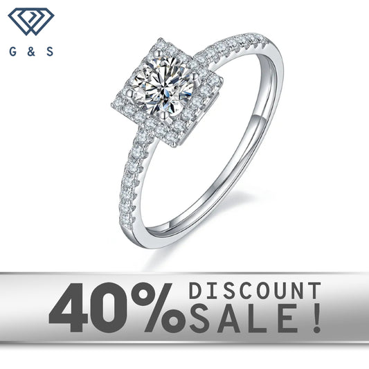 A 0.50ct moissanite sparkles within a delicate halo setting on a 9ct white gold band.