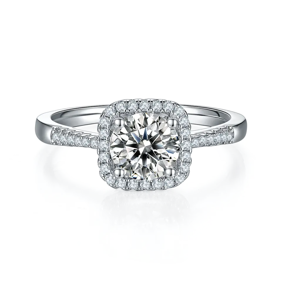 This beautiful ring showcases a brilliant 1.00ct moissanite encircled by a halo of smaller stones, all crafted in fine sterling silver.