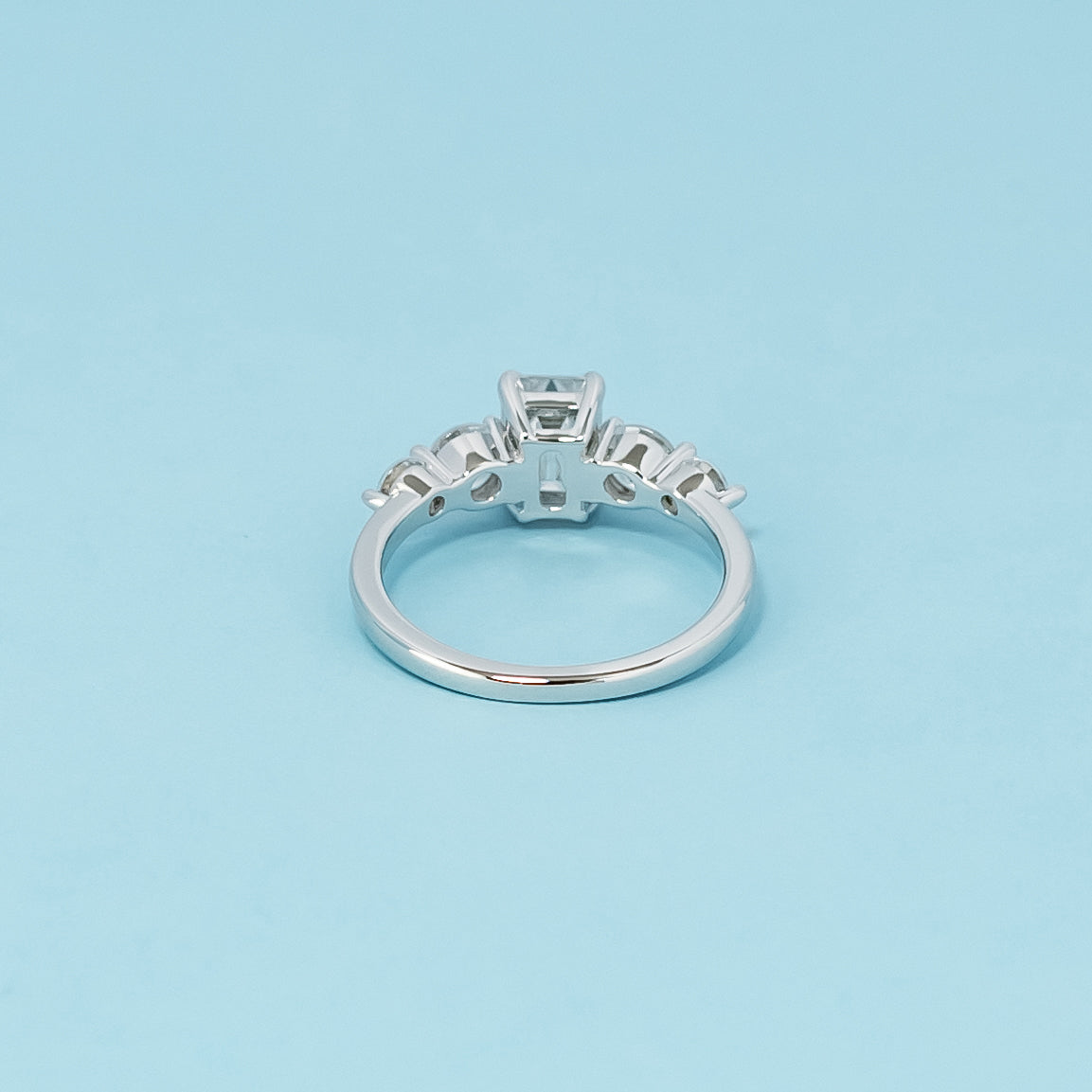Luxurious 9ct white gold engagement ring with five beautiful emerald cut moissanites, symbolizing enduring love and commitment.