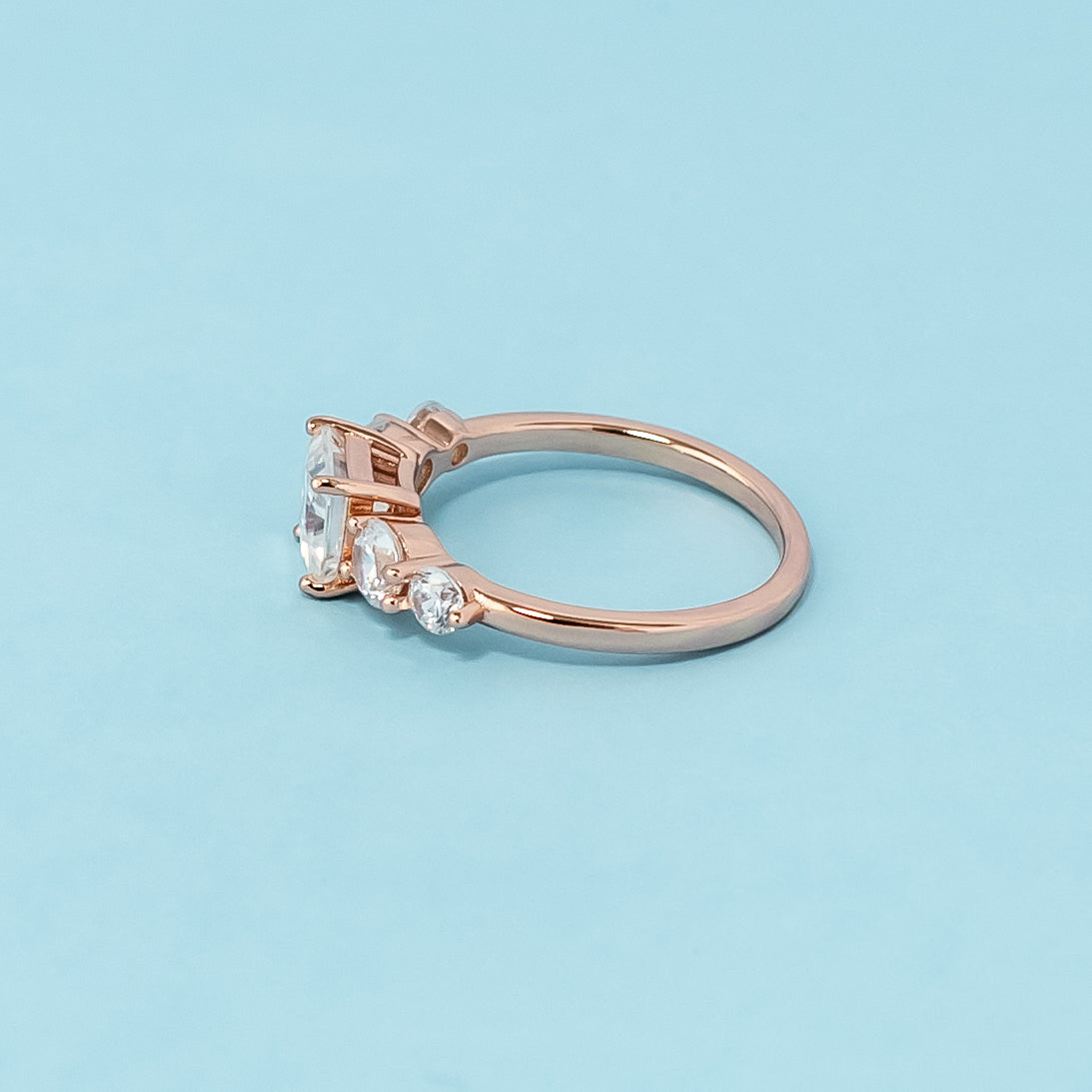Elegant rose gold engagement ring showcasing five sparkling princess cut moissanites in a classic design.