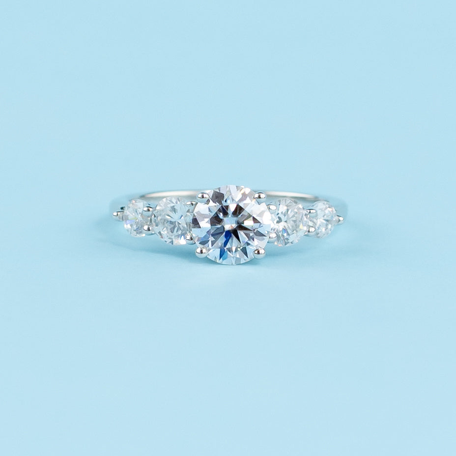 Elegant 9ct white gold engagement ring featuring five dazzling round brilliant moissanites.