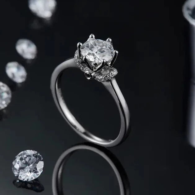 A romantic and detailed sterling silver engagement ring showcasing a dazzling 1.00ct moissanite within a floral setting, perfect for a nature lover.