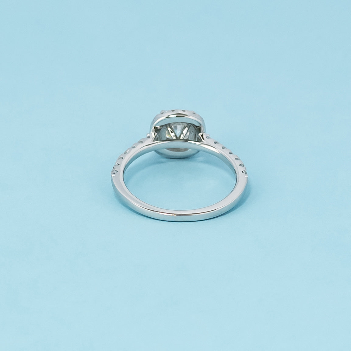 Luxurious 9ct white gold engagement ring with a classic halo setting that enhances the brilliance of the cushion cut moissanite.