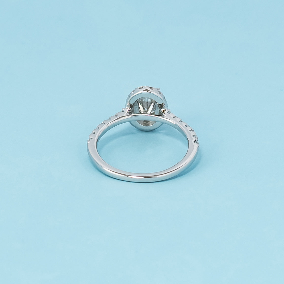Luxurious 9ct white gold engagement ring with a classic halo setting that enhances the brilliance of the oval cut moissanite.