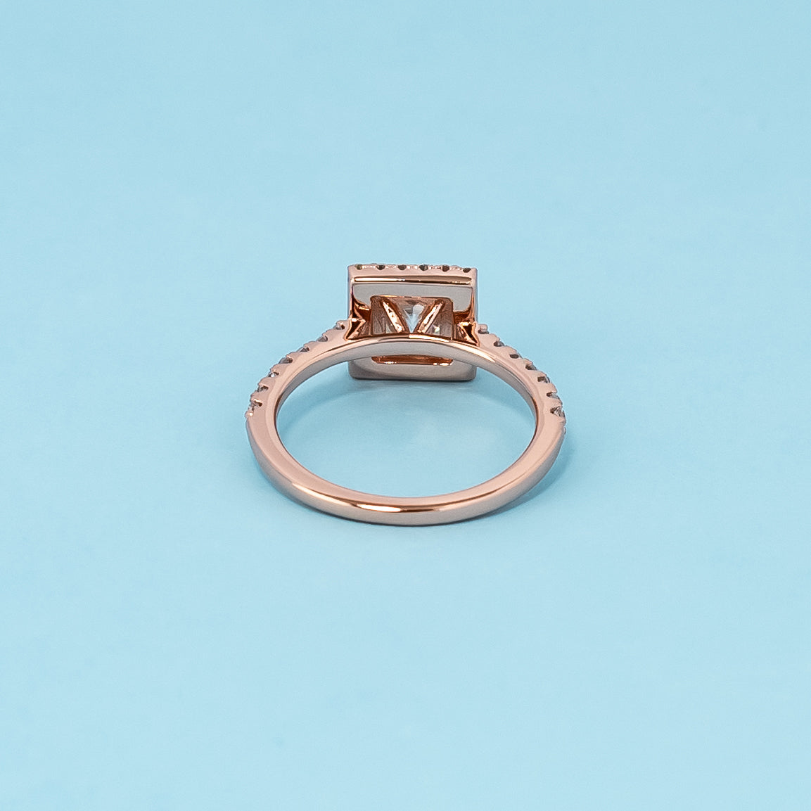 Timeless and luxurious 9ct rose gold engagement ring showcasing a beautiful princess cut moissanite with a classic halo design.
