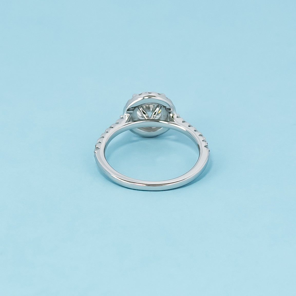 Luxurious 9ct white gold engagement ring with a classic halo setting that enhances the brilliance of the round brilliant moissanite.
