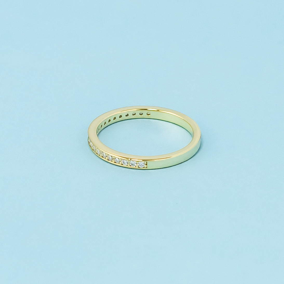 A beautifully crafted wedding band set in 9ct yellow gold, intricately adorned with pave-set moissanites, perfect for a lifetime of enduring sparkle.