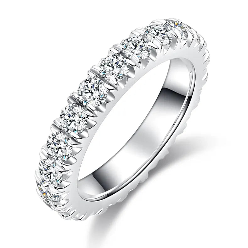 A close-up of a ring featuring stones set around the entire circumference.