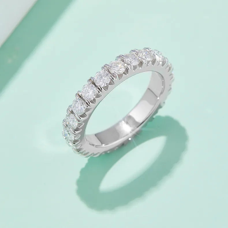 A ring featuring gemstones that extend around the entire band.