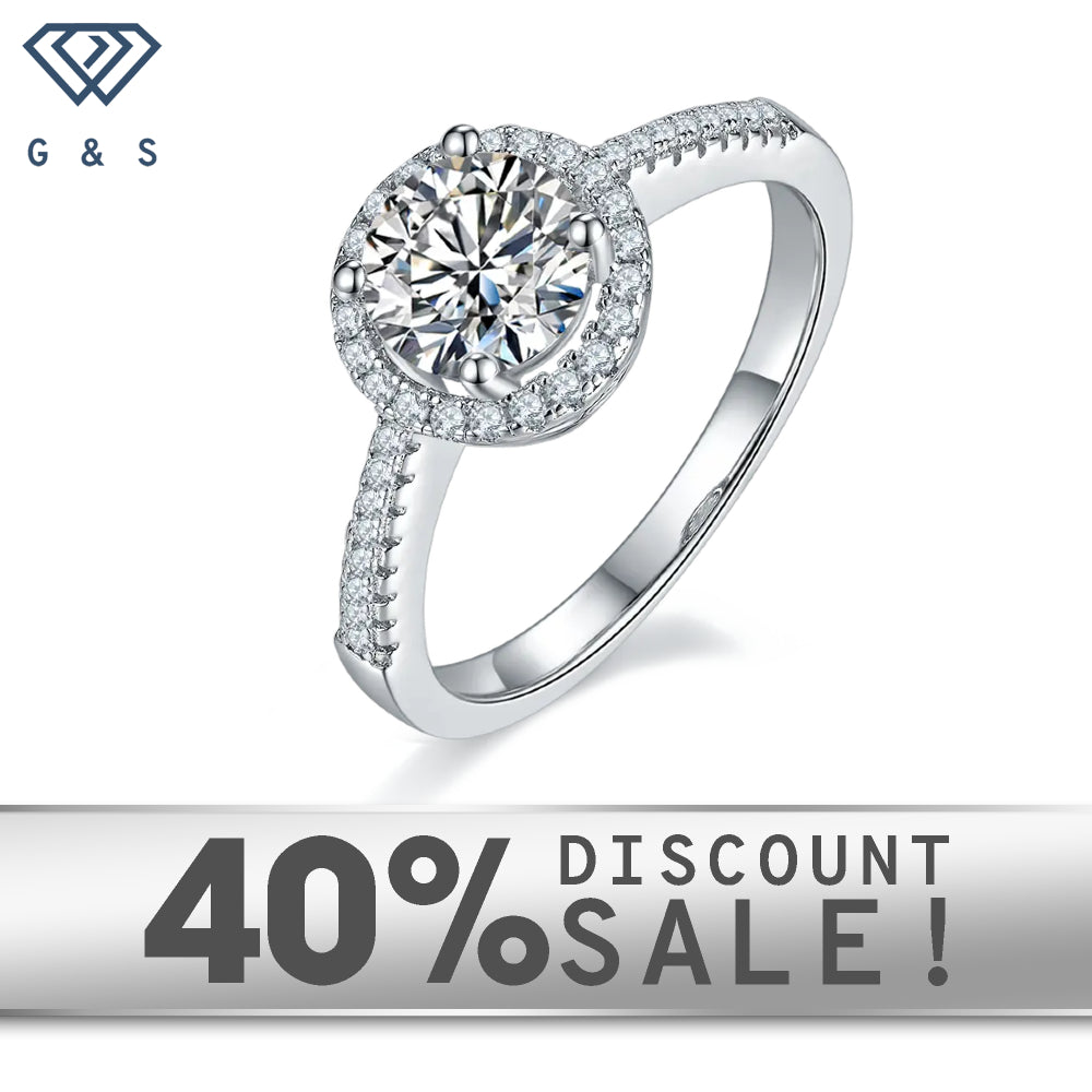A 1.00ct moissanite sparkles within a delicate halo of hearts, set in 9ct white gold.