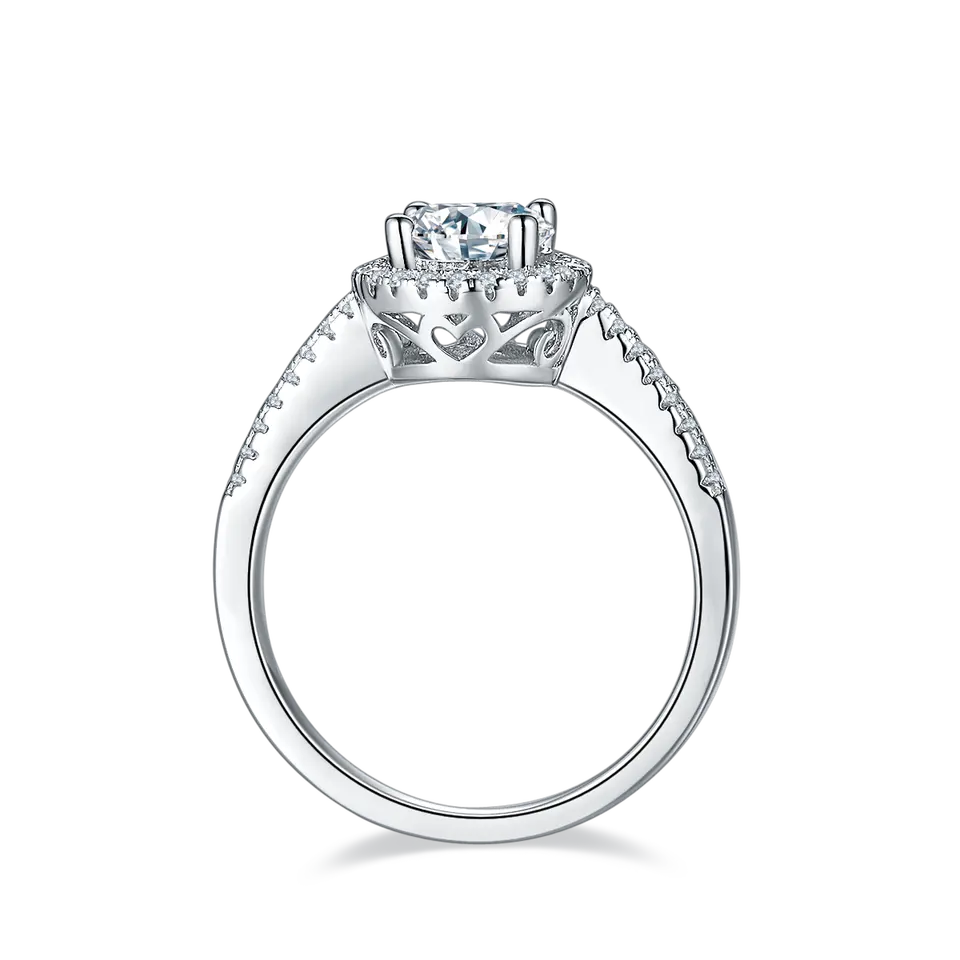 A beautiful sterling silver engagement ring with a central 1.00ct moissanite accentuated by a unique heart-shaped halo design.