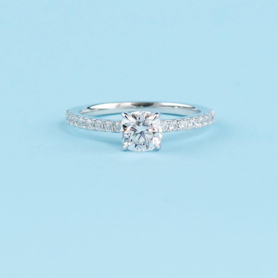 Elegant 9ct white gold engagement ring featuring a hidden setting that emphasizes the sparkle of the cushion cut moissanite.