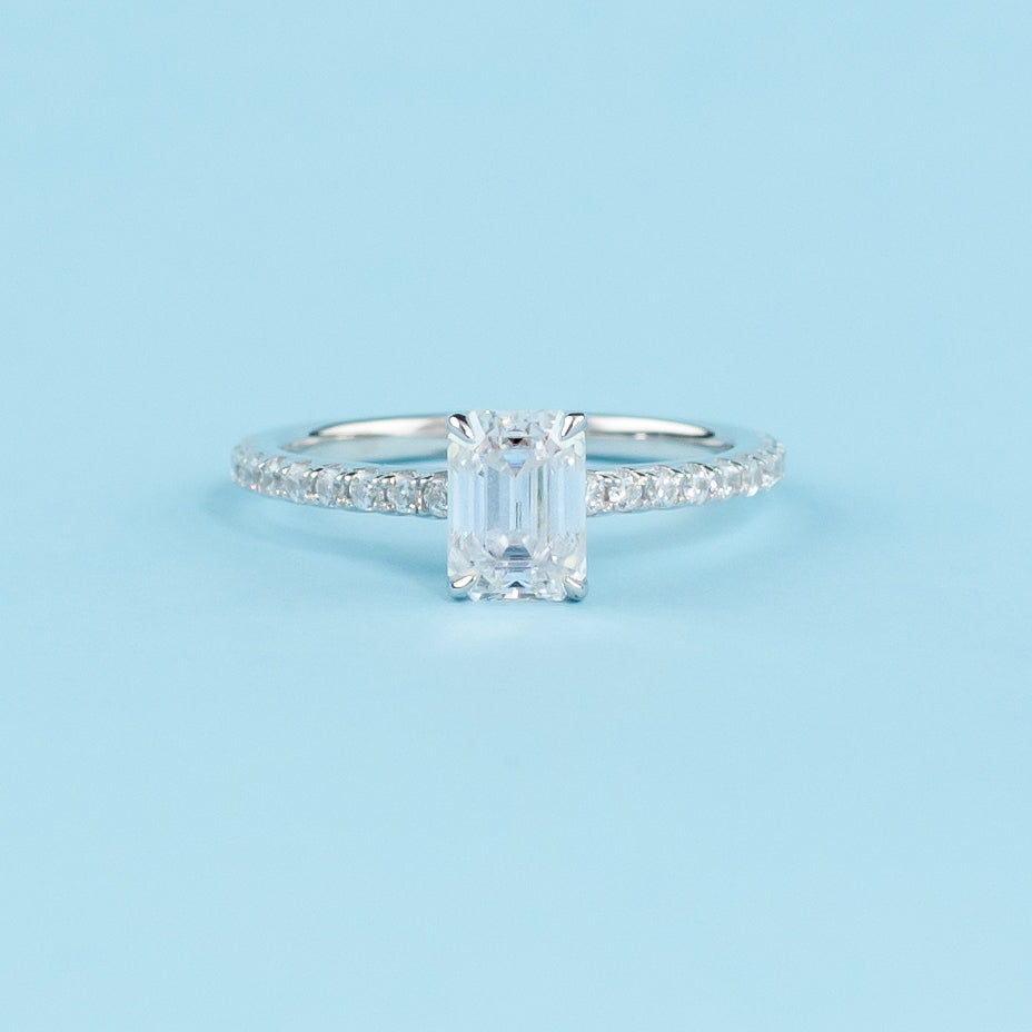 Elegant 9ct white gold engagement ring featuring a hidden setting for a sparkling emerald cut moissanite.