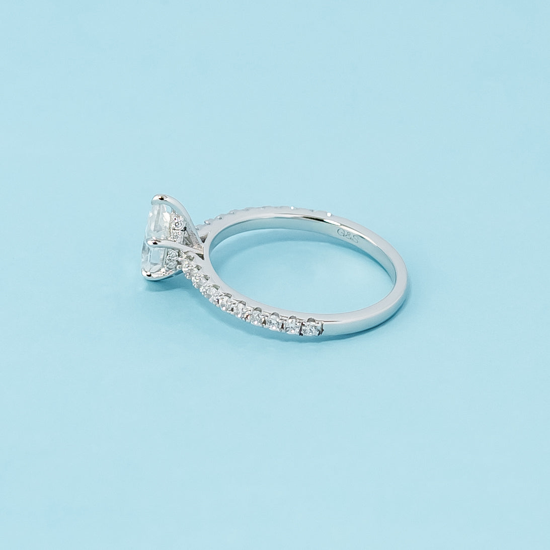 Modern and refined engagement ring showcasing a pear-shaped moissanite in a unique hidden setting, crafted in 9ct white gold.