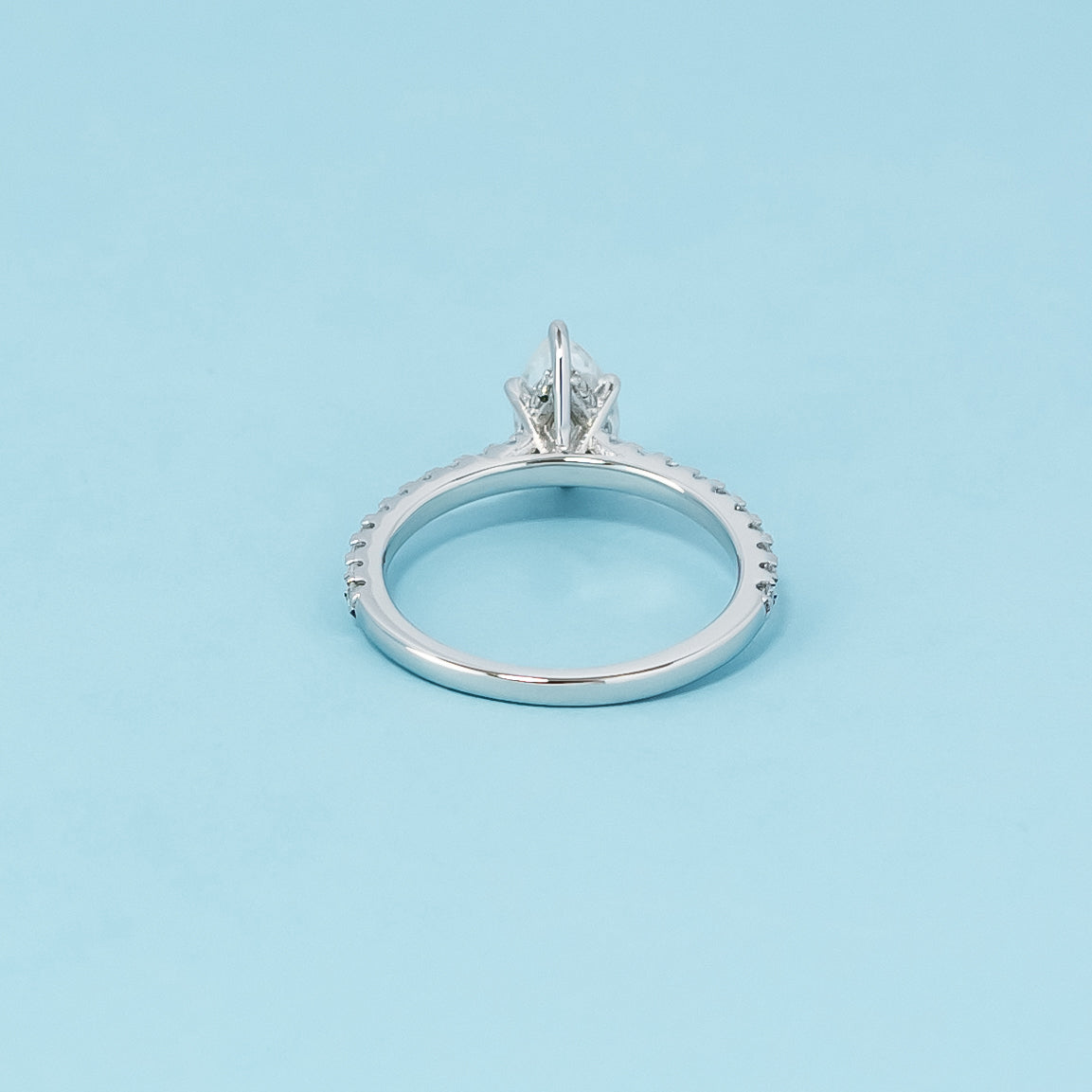 Luxurious 9ct white gold engagement ring with a discreet setting that highlights the beauty and brilliance of the pear-shaped moissanite.