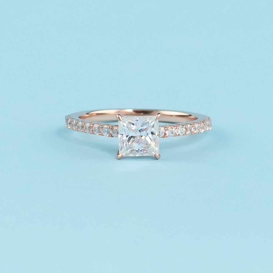 Elegant princess cut moissanite engagement ring with a hidden halo, set in warm 9ct rose gold.