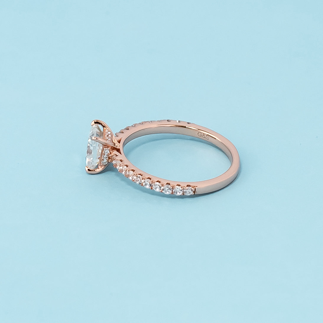 Stunning rose gold engagement ring featuring a sparkling princess cut moissanite and a unique hidden design.