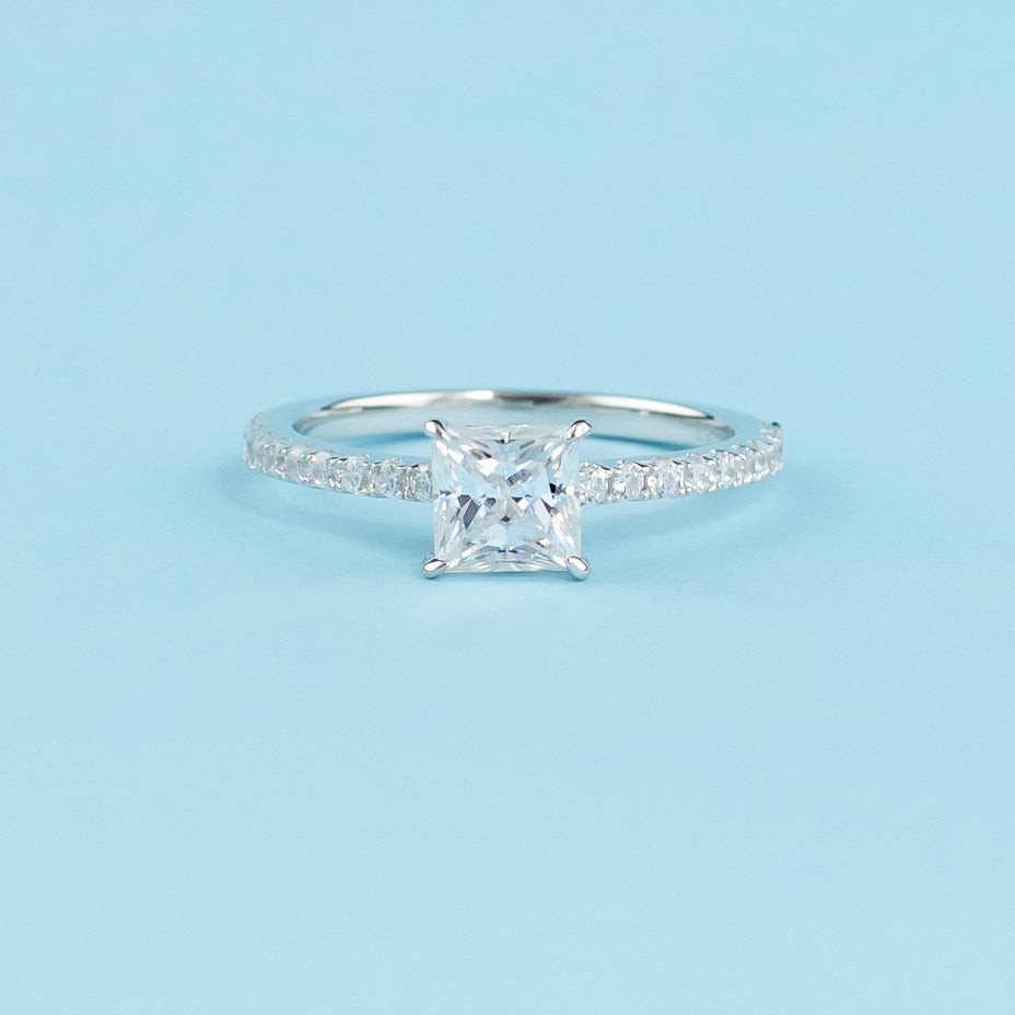 Elegant 9ct white gold engagement ring featuring a hidden setting for a sparkling princess cut moissanite.
