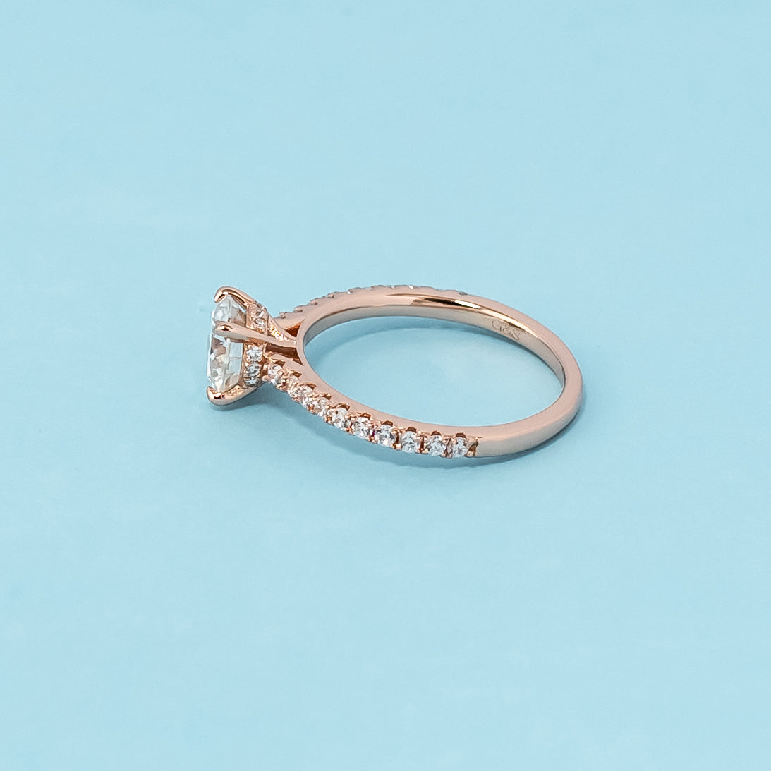 Stunning rose gold engagement ring featuring a sparkling round brilliant moissanite and a unique hidden design.