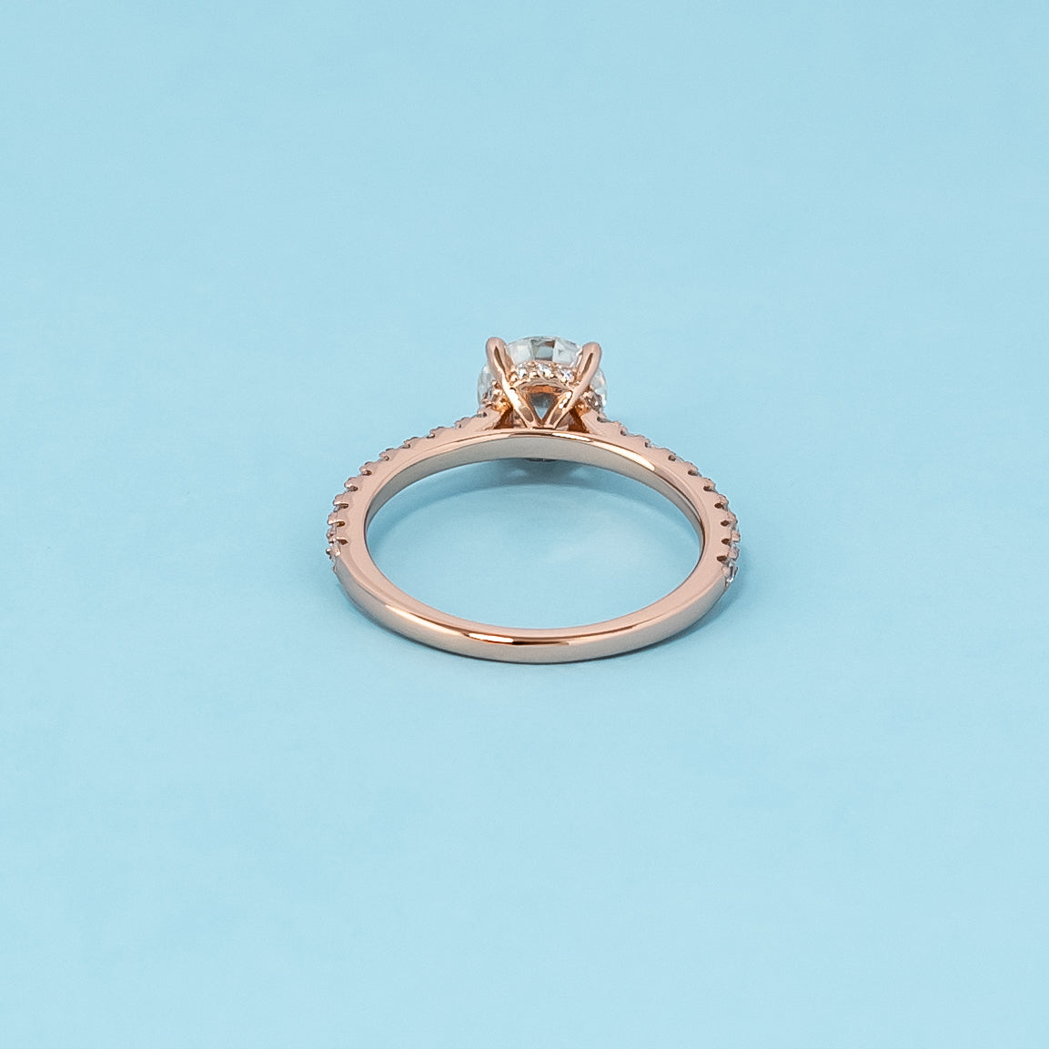 Luxurious 9ct rose gold engagement ring showcasing a beautiful round brilliant moissanite with a subtle hidden halo.