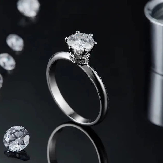 Experience the brilliance of a 1.00ct moissanite and the elegance of a hidden halo in this beautifully crafted sterling silver engagement ring.
