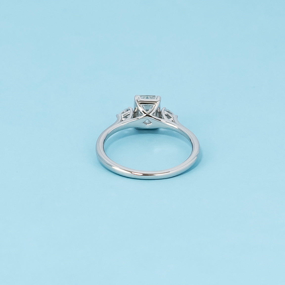 Luxurious 9ct white gold engagement ring with three beautiful emerald cut moissanites in a timeless trilogy setting, symbolizing infinite love.