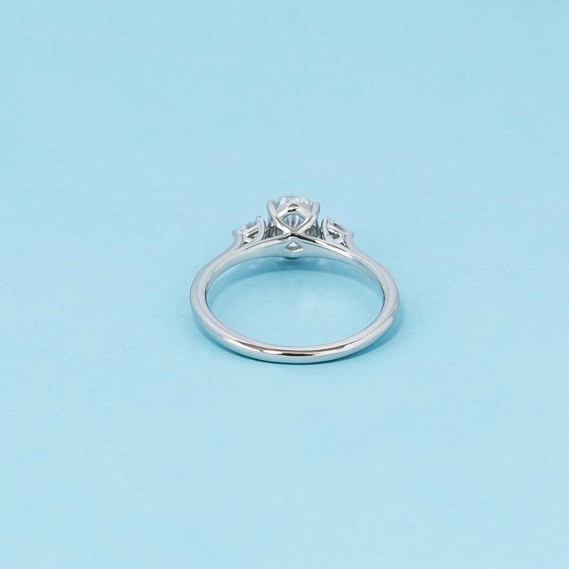 Luxurious 9ct white gold engagement ring with three stunning oval cut moissanites in a timeless trilogy setting, representing infinite love.