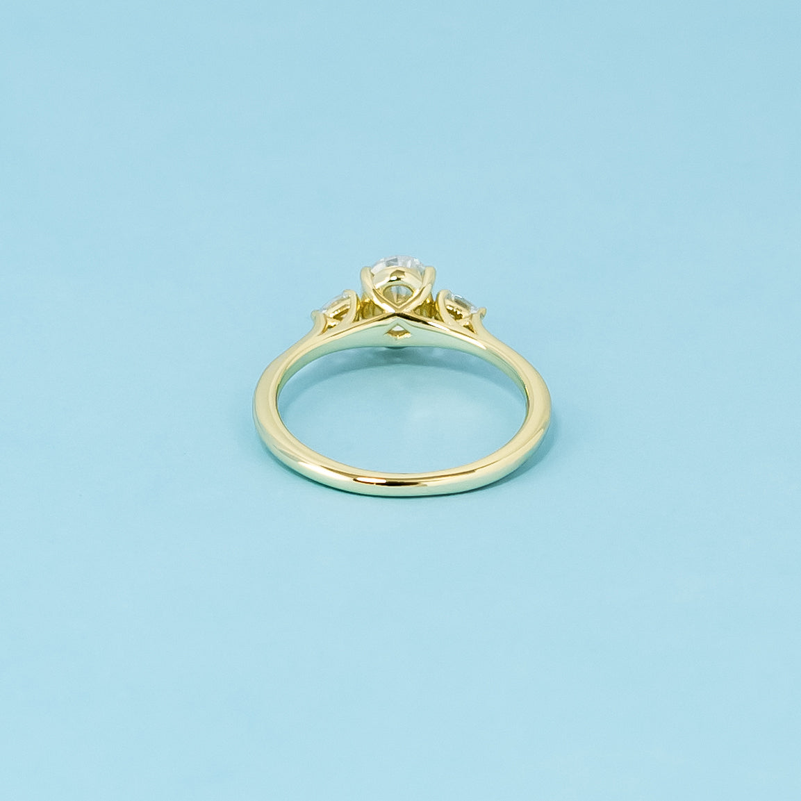 An elegant 9ct yellow gold engagement ring with three brilliant oval moissanites, a symbol of your everlasting bond.