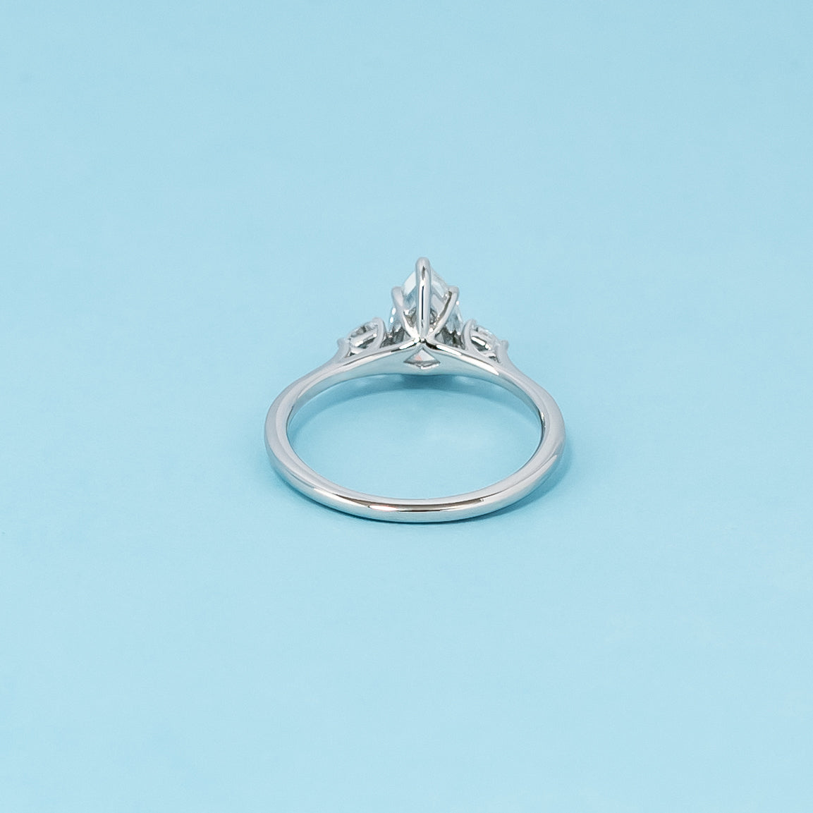 Luxurious 9ct white gold engagement ring with three stunning pear-shaped moissanites in a timeless trilogy setting, representing infinite love.