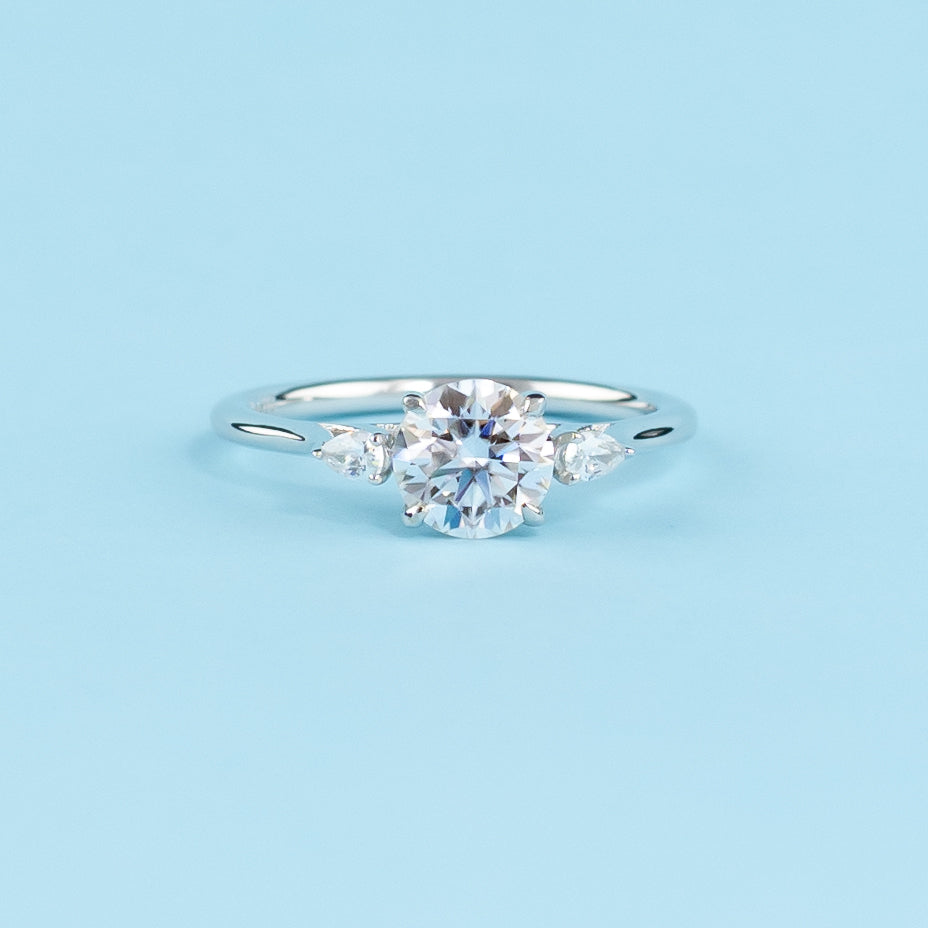 Elegant 9ct white gold engagement ring featuring a trilogy design with three dazzling round brilliant moissanites.