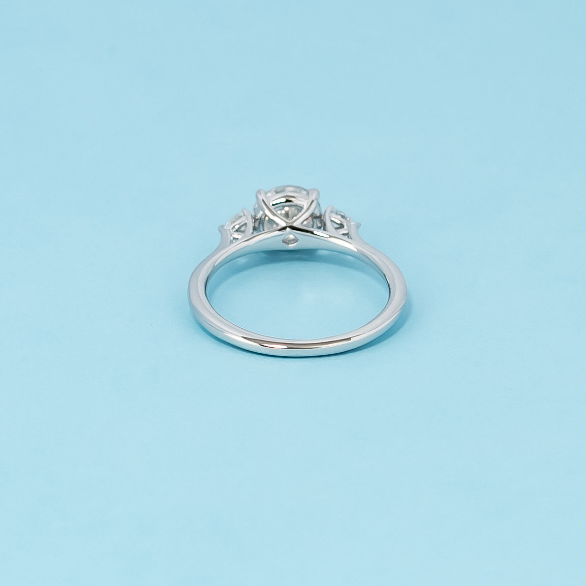 Luxurious 9ct white gold engagement ring with three stunning round brilliant moissanites in a timeless trilogy setting, representing infinite love.
