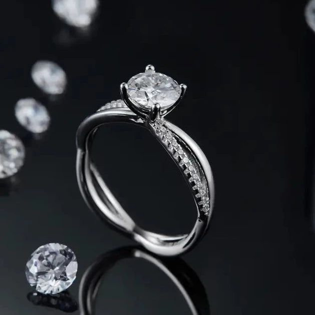 A sophisticated engagement ring crafted in sterling silver, featuring a dazzling 1.00ct moissanite and a smooth, flowing infinity band.