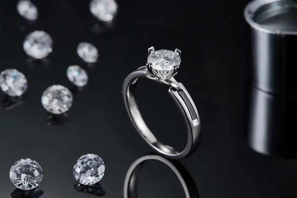 A detailed view highlighting the brilliance of the 1.00ct moissanite and the intricate infinity design on the sterling silver band of this engagement ring.