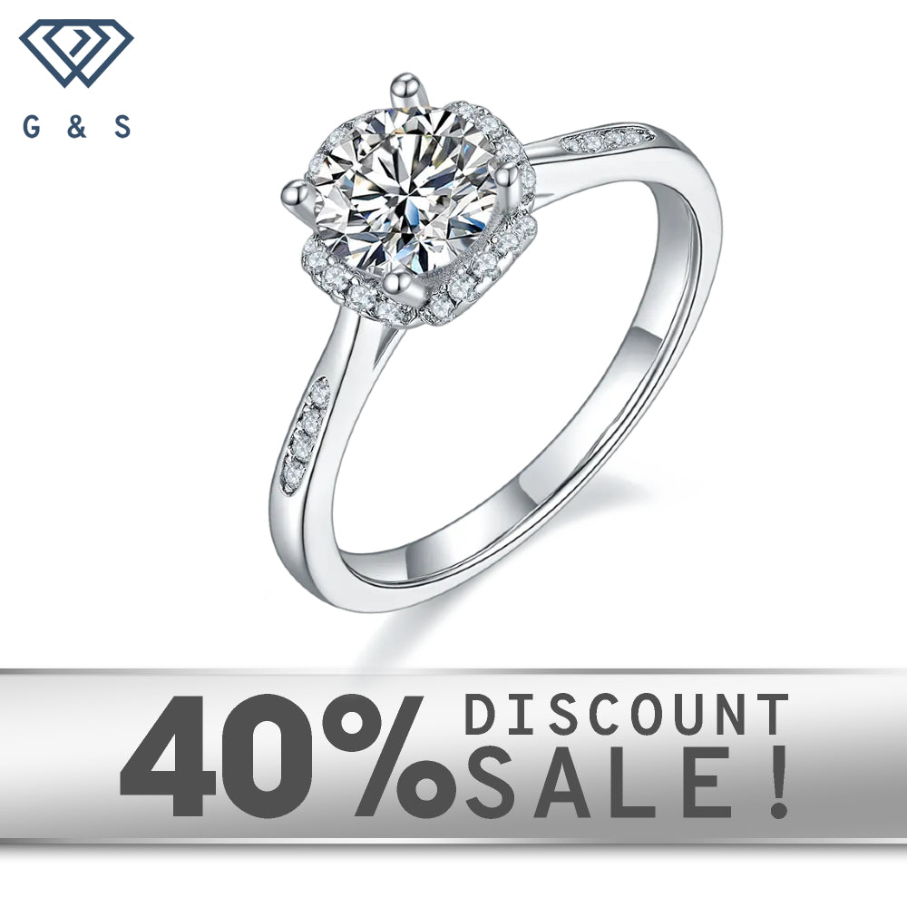 A 1.00ct moissanite sparkles within a contemporary halo setting on a 9ct white gold band.