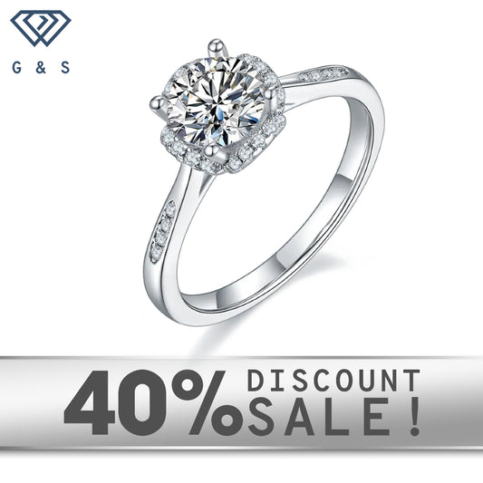 A 1.00ct moissanite sparkles within a contemporary halo setting on a 9ct white gold band.