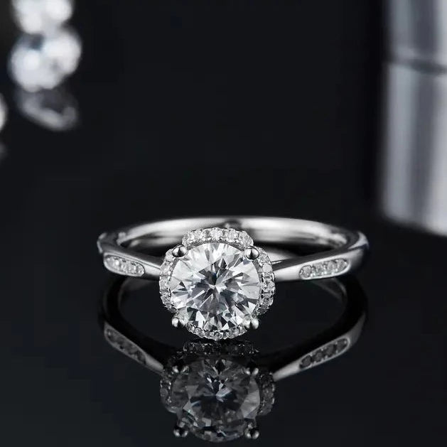 A beautiful 1.00ct moissanite engagement ring with a unique and modern halo design in 9ct white gold.