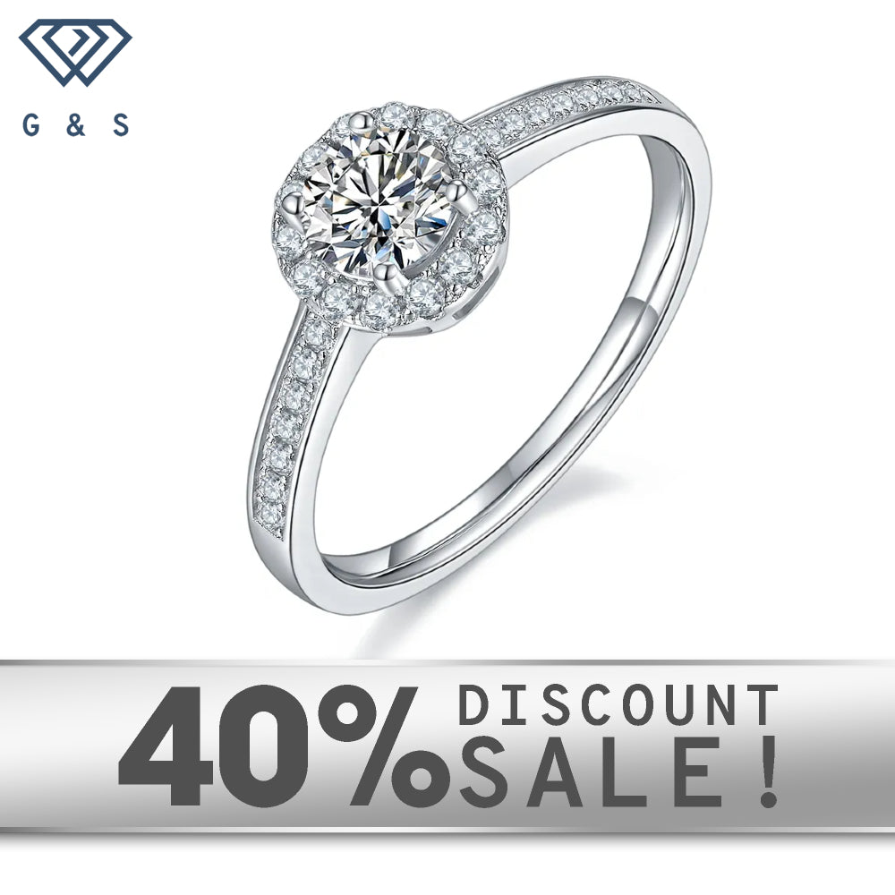 A 0.50ct moissanite sparkles within a pave halo setting on a 9ct white gold band.