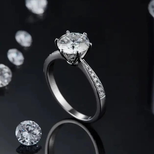 A beautiful 2.00ct moissanite engagement ring with a timeless Tiffany 6-claw setting, enhanced by a sparkling pave band, all crafted in sterling silver.