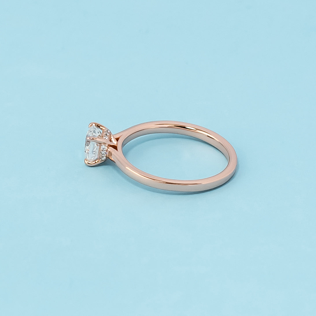 Stunning rose gold engagement ring featuring a sparkling cushion cut moissanite and a secret sparkle hidden halo design.