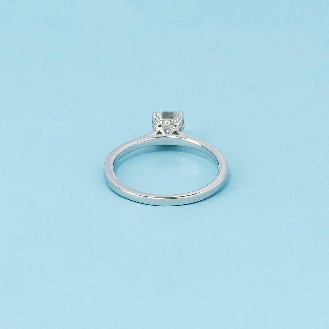 Luxurious 9ct white gold engagement ring with a discreet hidden halo setting that enhances the brilliance of the cushion cut moissanite.