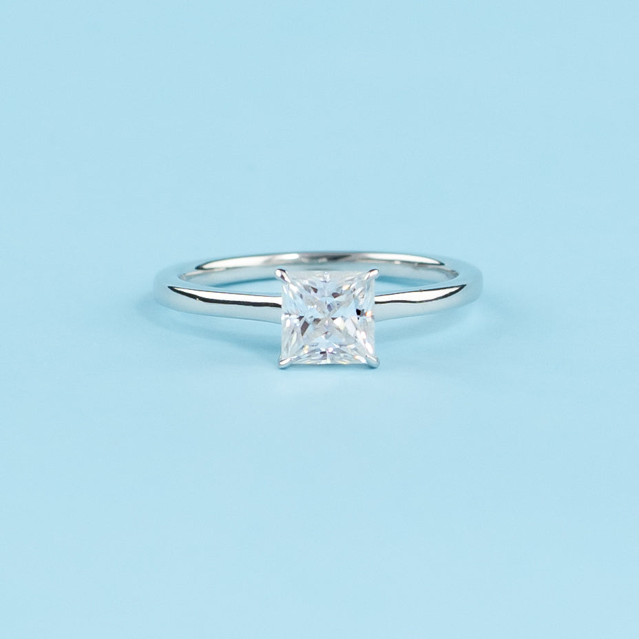 Elegant 9ct white gold engagement ring featuring a princess cut moissanite with a hidden halo for added sparkle.