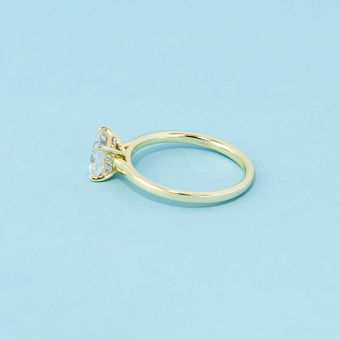 This 9ct yellow gold ring features a classic princess cut moissanite with a hidden halo for a touch of surprise.